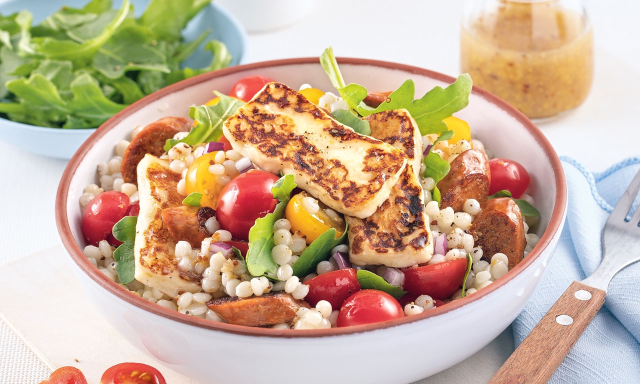 Warm couscous salad with merguez sausage and halloumi cheese
